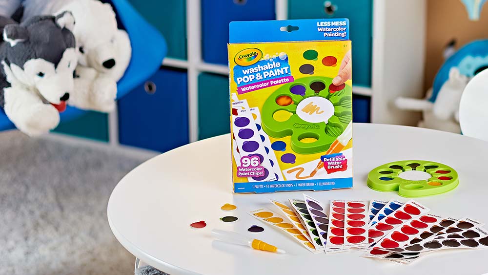 Crayola pop and paints on a table.