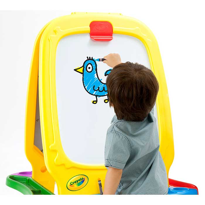 Deluxe Magnetic Double-sided Easel. Child drawing a bird on the whiteboard.