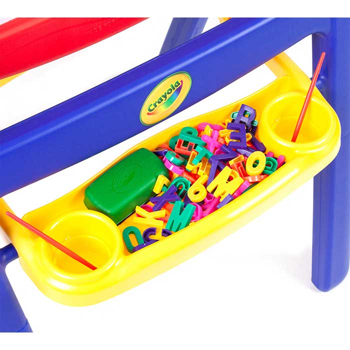 Qwikflip 2-sided easel. close up of paint cup tray filled with magnetic letters and eraser.